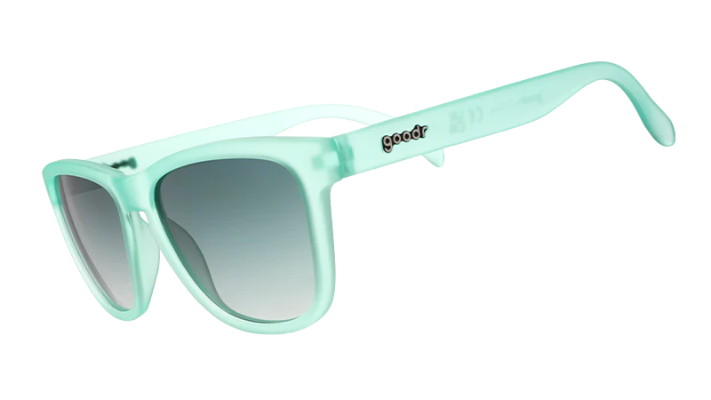 Product closeup of mint coloured square-framed sunglasses, with dark green gradient lenses.