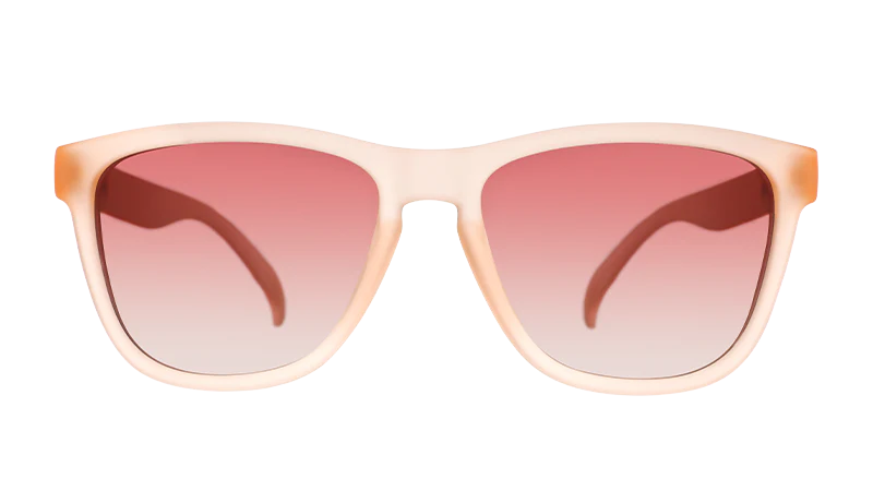 Product close up of pink square-shaped sunglasses with pink gradient lenses.