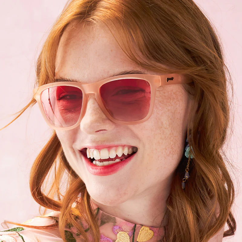 Women's style and fit showcase of pink square-shaped sunglasses with pink gradient lenses.