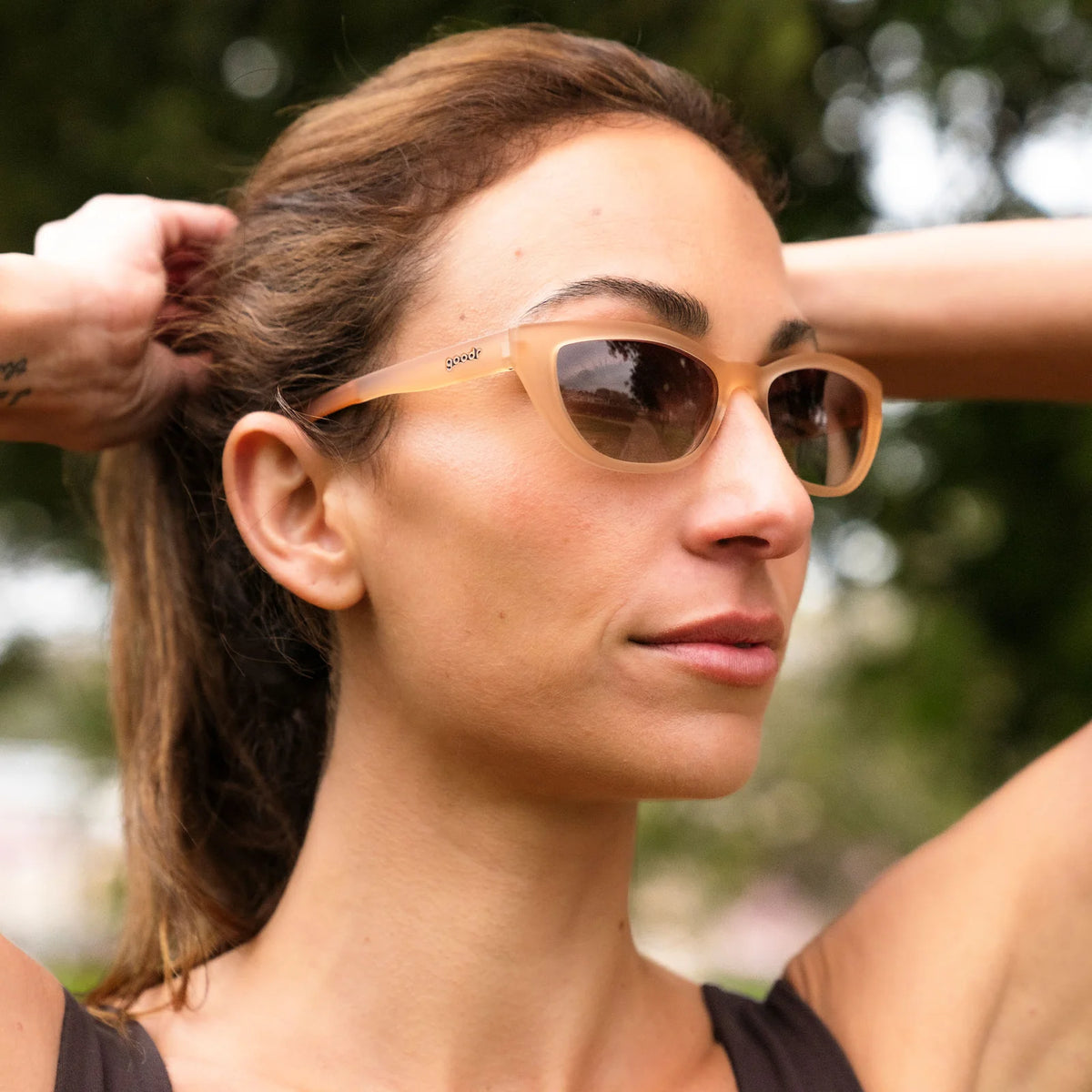 Fit and style showcase of translucent brown sunglasses in a cat-eye shape. Polarised brown gradient lenses with UV400 protection.