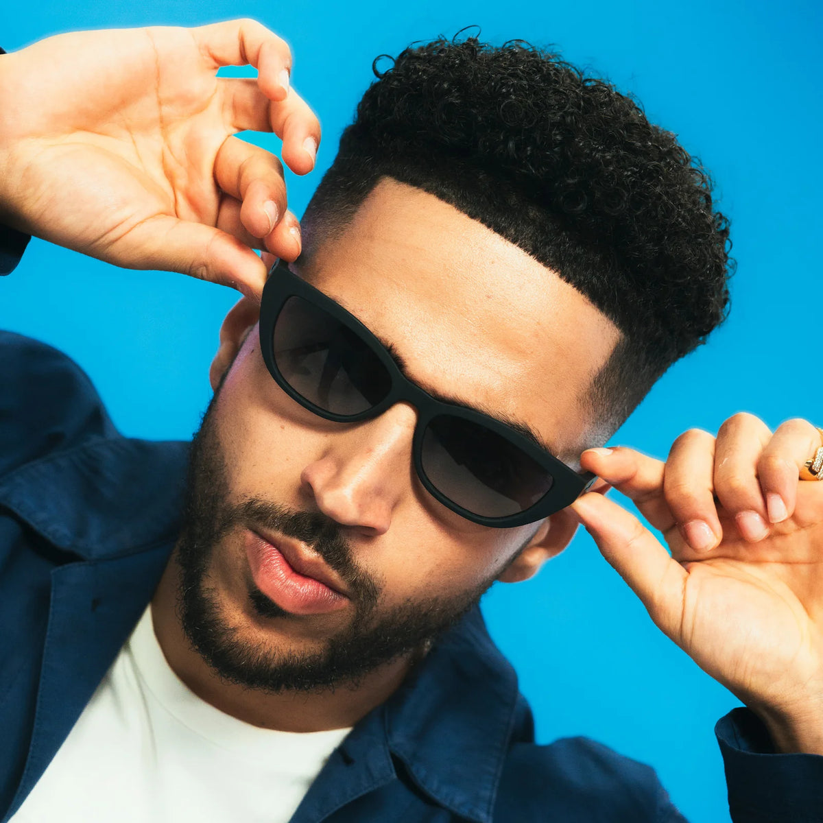 Style and fit showcase of black sunglasses with dark, gradient lenses. Simple and stylish cat-eye frames.